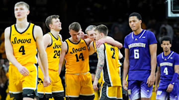 The Iowa Hawkeyes huddle as Iowa Hawkeyes guard Josh Dix (4) prepares the shoot free throws in the final minutes against the Washington Huskies Saturday, Feb. 22, 2025 at Carver-Hawkeye Arenain Iowa City, Iowa.