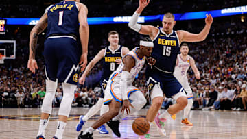 May 11, 2025; Denver, Colorado, USA; Oklahoma City Thunder guard Shai Gilgeous-Alexander (2) controls the ball against Denver Nuggets center Nikola Jokic (15), guard Christian Braun (0) and forward Michael Porter Jr. (1) in the first quarter during Game 4 of the second round at Ball Arena. Mandatory Credit: Isaiah J. Downing-Imagn Images