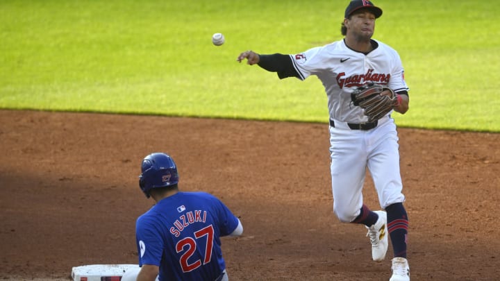 Aug 14, 2024; Cleveland, Ohio, USA; Cleveland Guardians shortstop Tyler Freeman (2) throws to first base beside Chicago Cubs right fielder Seiya Suzuki (27) in the third inning at Progressive Field. Mandatory Credit: David Richard-USA TODAY Sports