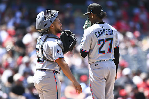  Miami Marlins catcher Agustín Ramírez (50) and starting pitcher Edward Cabrera (27) meet