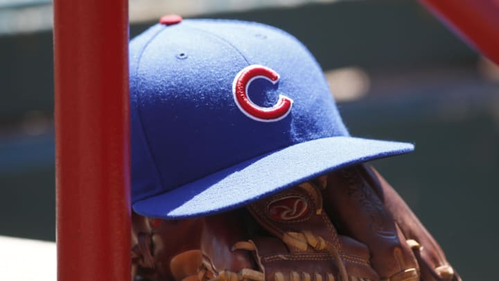 Apr 26, 2015; Cincinnati, OH, USA; A Chicago Cubs hat and glove sits in the dugout during a game with the Cincinnati Reds at Great American Ball Park.