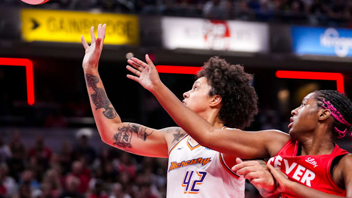 Phoenix Mercury center Brittney Griner (42) and Indiana Fever forward Aliyah Boston (7) fight for a loose ball Friday, Aug. 16, 2024, during the game at Gainbridge Fieldhouse in Indianapolis. Phoenix Mercury center Brittney Griner (42) and Indiana Fever forward Aliyah Boston (7) fight for a loose ball Friday, Aug. 16, 2024, during the game at Gainbridge Fieldhouse in Indianapolis.