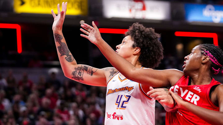Phoenix Mercury center Brittney Griner (42) and Indiana Fever forward Aliyah Boston (7) fight for a loose ball Friday, Aug. 16, 2024, during the game at Gainbridge Fieldhouse in Indianapolis.