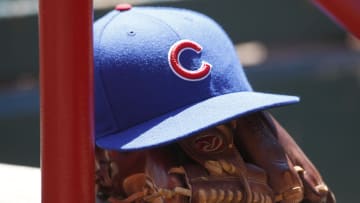 Apr 26, 2015; Cincinnati, OH, USA; A Chicago Cubs hat and glove sits in the dugout during a game with the Cincinnati Reds at Great American Ball Park.