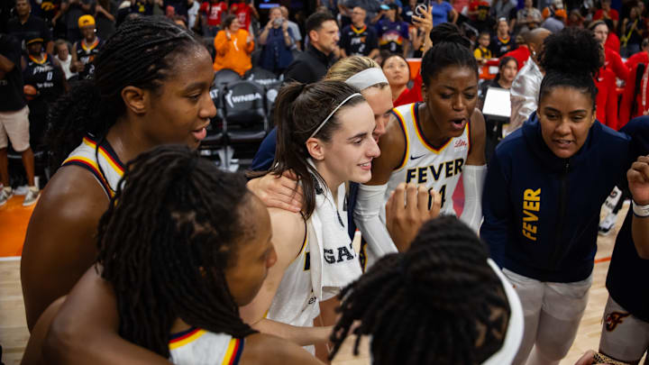 Jun 30, 2024; Phoenix, Arizona, USA; Indiana Fever guard Caitlin Clark (22) in the huddle with teammates against the Phoenix Mercury during a WNBA game at Footprint Center. Mandatory Credit: Mark J. Rebilas-Imagn Images