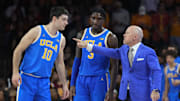 Jan 27, 2025; Los Angeles, California, USA; UCLA Bruins head coach Mick Cronin talks with guard Lazar Stefanovic (10) and guard Eric Dailey Jr. (3) against the Southern California Trojans at the Galen Center. Mandatory Credit: Kirby Lee-Imagn Images