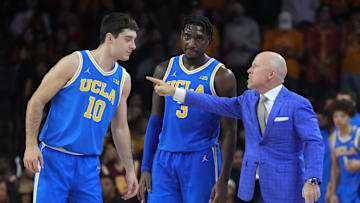 Jan 27, 2025; Los Angeles, California, USA; UCLA Bruins head coach Mick Cronin talks with guard Lazar Stefanovic (10) and guard Eric Dailey Jr. (3) against the Southern California Trojans at the Galen Center. Mandatory Credit: Kirby Lee-Imagn Images