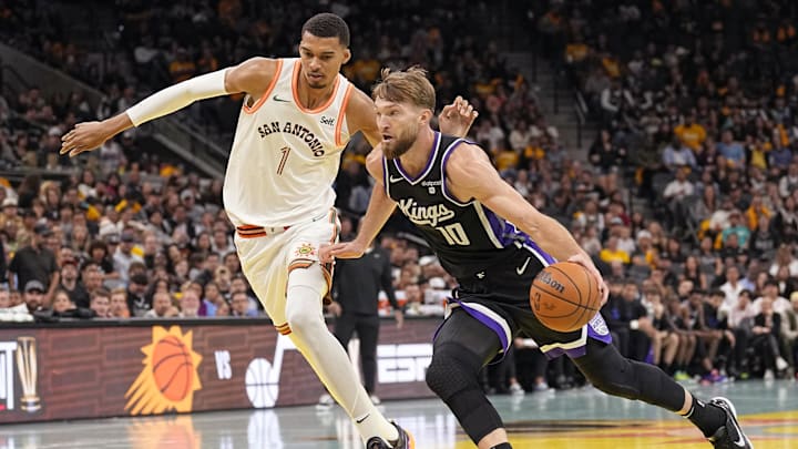 Nov 17, 2023; San Antonio, Texas, USA; Sacramento Kings center Domantas Sabonis (10) drives to the basket past San Antonio Spurs forward Victor Wembanyama (1) during the second half at Frost Bank Center. Mandatory Credit: Scott Wachter-Imagn Images