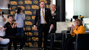 Ben McCollum, Iowa's new head men's basketball coach, walks to the podium during his introductory press conference Tuesday, March 25, 2025 at Carver-Hawkeye Arena in Iowa City, Iowa.