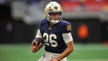 Oct 19, 2024; Atlanta, Georgia, USA; Notre Dame Fighting Irish holder Tyler Buchner (26) runs the ball on a fake field goal against the Georgia Tech Yellow Jackets in the fourth quarter at Mercedes-Benz Stadium. 