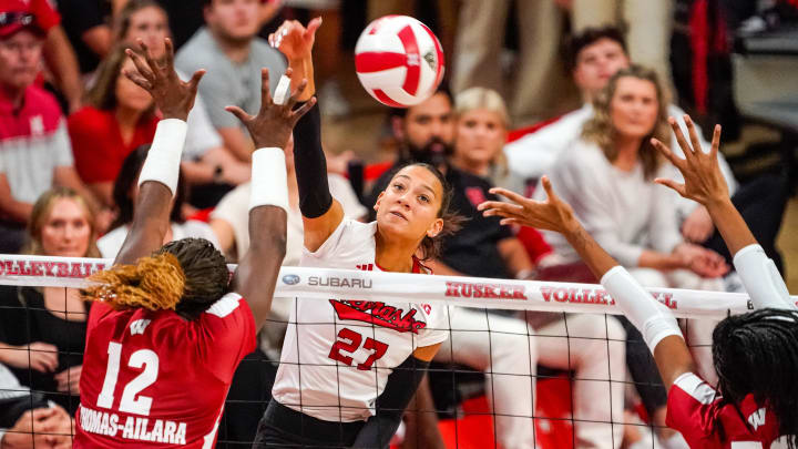 Oct 21, 2023; Lincoln, NE, USA; Nebraska Cornhuskers outside hitter Harper Murray (27) attacks against Wisconsin Badgers outside hitter Temi Thomas-Ailara (12) during the fourth set at the Bob Devaney Sports Center.