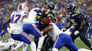 Oct 27, 2024; Seattle, Washington, USA; Buffalo Bills safety Damar Hamlin (3, left) and defensive tackle Eli Ankou (51) tackle Seattle Seahawks running back Kenneth Walker III (9) short of the end zone during the second quarter at Lumen Field. Mandatory Credit: Joe Nicholson-Imagn Images