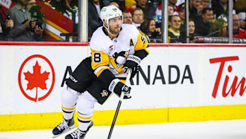 Oct 22, 2024; Calgary, Alberta, CAN; Pittsburgh Penguins defenseman Kris Letang (58) skates with the puck against the Calgary Flames during the second period at Scotiabank Saddledome. Mandatory Credit: Sergei Belski-Imagn Images