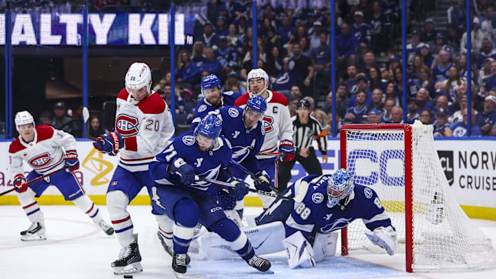 Apr 19, 2026; Tampa, Florida, USA; the puck goes past Montreal Canadiens forward Juraj Slafkovsky (20), Tampa Bay Lightning forward Anthony Cirelli (71), defenseman Ryan McDonagh (27), and goalie Andrei Vasilevskiy (88) during the second period in game one of the first round of the 2026 Stanley Cup Playoffs at Benchmark International Arena. Mandatory Credit: Morgan Tencza-Imagn Images