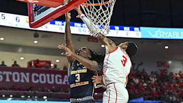 Houston guard Ramon Walker Jr. blocks a layup from Northern Colorado guard Langston Reynolds during the first half at Fertitta Center in Houston on Nov. 7, 2022. 