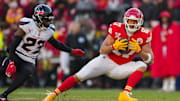 Dec 21, 2024; Kansas City, Missouri, USA; Kansas City Chiefs tight end Travis Kelce (87) catches a pass against Houston Texans safety Eric Murray (23) during the second half at GEHA Field at Arrowhead Stadium. Mandatory Credit: Jay Biggerstaff-Imagn Images