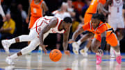 Oklahoma Sooners guard Duke Miles (15) and Oklahoma State Cowboys guard Jamyron Keller (14) dive for the ball during a men's college Bedlam basketball game between the University of Oklahoma Sooners (OU) and the Oklahoma State University Cowboys (OSU) at Paycom Center in Oklahoma City, Saturday, Dec. 14, 2024.
