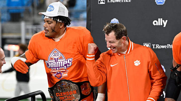 Dec 7, 2024; Charlotte, NC, USA; Clemson Tigers head coach Dabo Swinney celebrates on the podium after winning the 2024 ACC Championship game at Bank of America Stadium. Dec 7, 2024; Charlotte, NC, USA; Clemson Tigers head coach Dabo Swinney celebrates on the podium after winning the 2024 ACC Championship game at Bank of America Stadium.