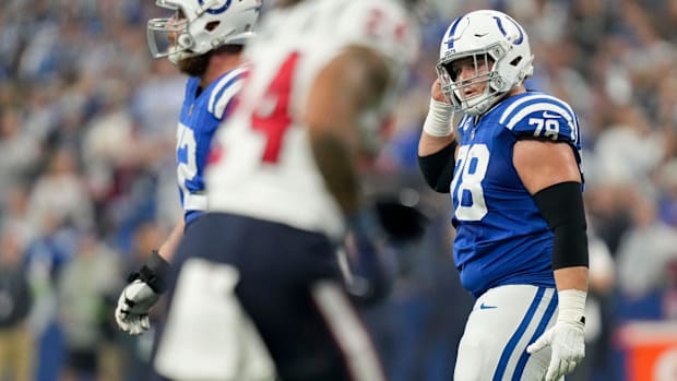 Colts center Ryan Kelly (blue jersey; white helmet) walks off the field after an offensive set. 