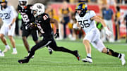 Oct 12, 2023; Houston, Texas, USA; Houston Cougars running back Stacy Sneed (21) runs the ball while West Virginia Mountaineers linebacker Caden Biser (36) applies pressure during the fourth quarter at TDECU Stadium. Mandatory Credit: Maria Lysaker-Imagn Images