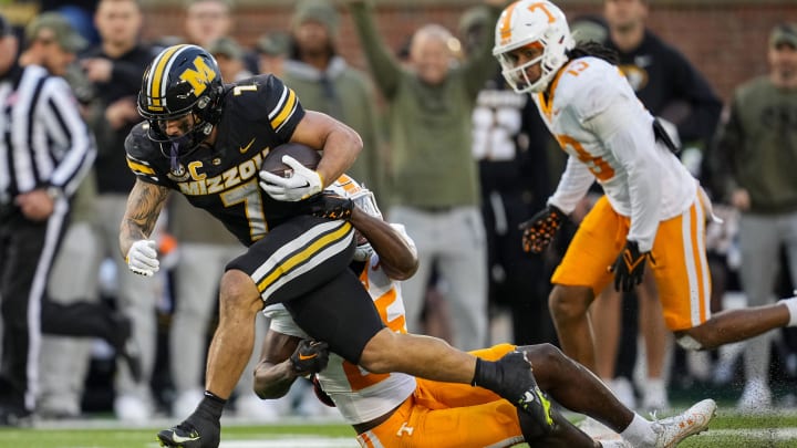 Nov 11, 2023; Columbia, Missouri, USA; Missouri Tigers running back Cody Schrader (7) runs the ball against Tennessee Volunteers defensive back Jourdan Thomas (25) during the second half at Faurot Field at Memorial Stadium. Mandatory Credit: Jay Biggerstaff-USA TODAY Sports