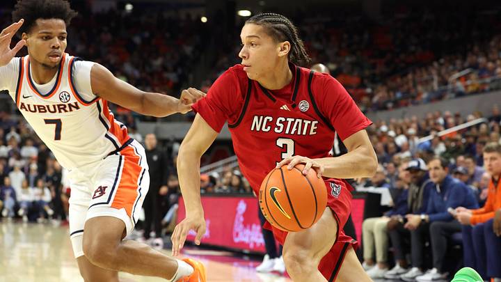 Dec 3, 2025; Auburn, Alabama, USA;  NC State Wolfpack guard Matt Able (3) drives against Auburn Tigers guard Keyshawn Hall (7) during the first half at Neville Arena. Mandatory Credit: John Reed-Imagn Images