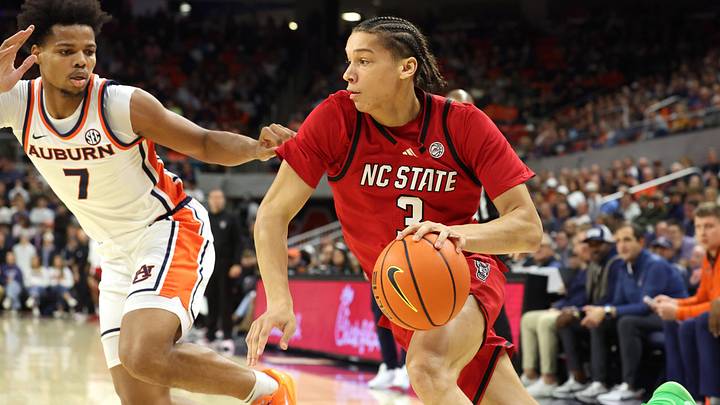 Dec 3, 2025; Auburn, Alabama, USA;  NC State Wolfpack guard Matt Able (3) drives against Auburn Tigers guard Keyshawn Hall (7) during the first half at Neville Arena. Mandatory Credit: John Reed-Imagn Images