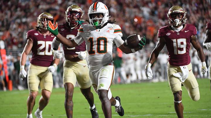 Oct 4, 2025; Tallahassee, Florida, USA; Miami Hurricanes wide receiver Malachi Toney (10) scores a touchdown against Florida State Seminoles defensive back Earl Little Jr. and defensive back Jerry Wilson (19) during the second half at Doak S. Campbell Stadium. Mandatory Credit: Robert Myers-Imagn Images
