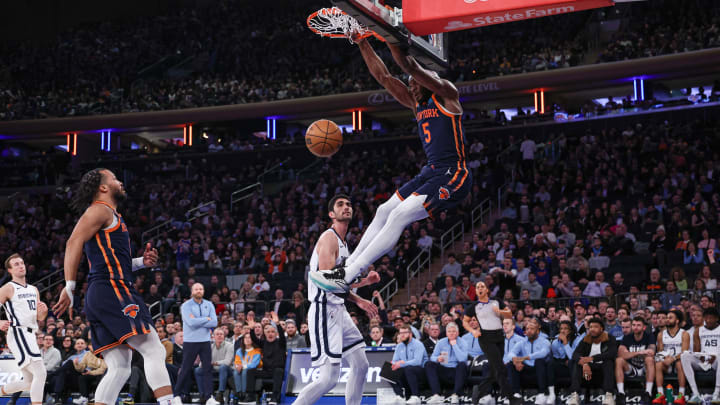 Feb 6, 2024; New York, New York, USA; New York Knicks forward Precious Achiuwa (5) dunks in front of Memphis Grizzlies forward Santi Aldama (7) during the first half at Madison Square Garden. Mandatory Credit: Vincent Carchietta-USA TODAY Sports