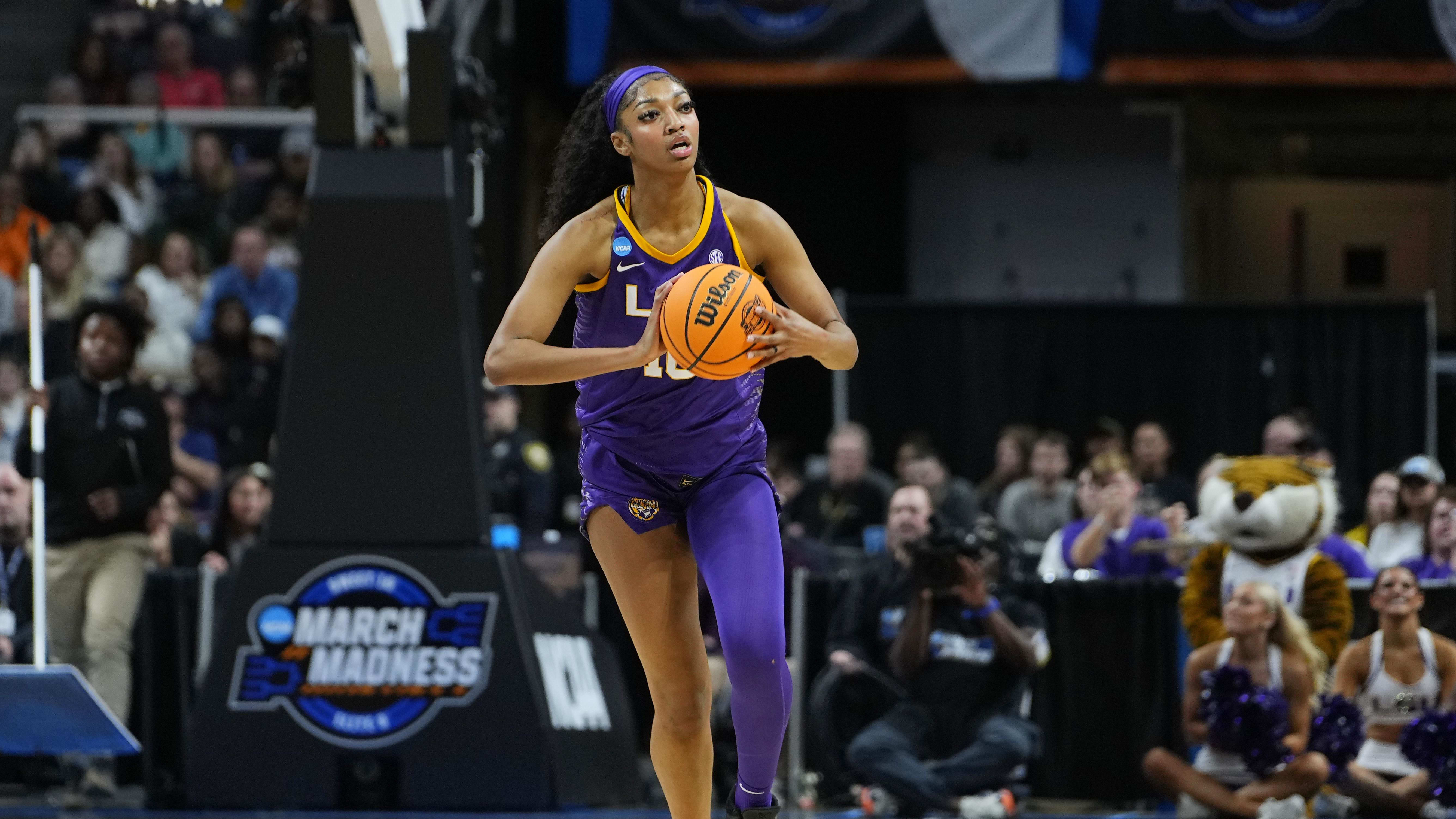 LSU Tigers forward Angel Reese passes the ball in the Elite Eight against Iowa.