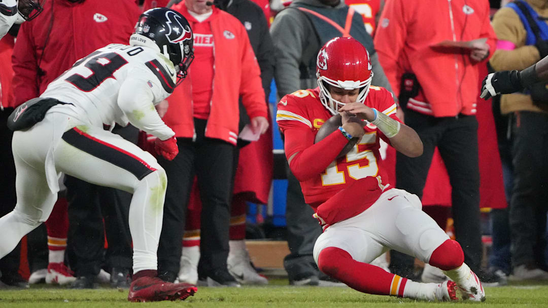 Jan 18, 2025; Kansas City, Missouri, USA; Kansas City Chiefs quarterback Patrick Mahomes (15) slides against Houston Texans linebacker Henry To'oTo'o (39) during the fourth quarter of a 2025 AFC divisional round game at GEHA Field at Arrowhead Stadium. Mandatory Credit: Denny Medley-Imagn Images