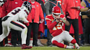 Jan 18, 2025; Kansas City, Missouri, USA; Kansas City Chiefs quarterback Patrick Mahomes (15) slides against Houston Texans linebacker Henry To'oTo'o (39) during the fourth quarter of a 2025 AFC divisional round game at GEHA Field at Arrowhead Stadium. Mandatory Credit: Denny Medley-Imagn Images