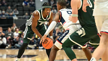 Oct 28, 2025; Hartford, CT, USA; Michigan State Spartans guard Trey Fort (9) looks to pass the ball defended by Connecticut Huskies guard Alec Millender (9) during the second half at PeoplesBank Arena. Mandatory Credit: Mark Smith-Imagn Images