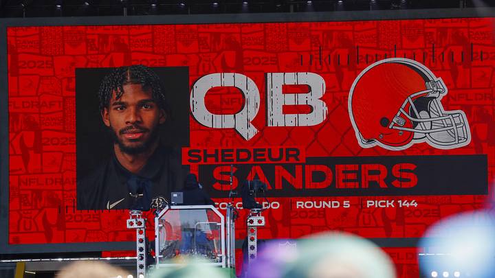 Apr 25, 2025; Green Bay, WI, USA; A graphic announcing Colorado quarterback Shedeur Sanders’ selection by the Cleveland Browns with the 144th overall pick is seen in the Draft Theater during the third day of the 2025 NFL Draft at Lambeau Field. Mandatory Credit: Tork Mason/USA Today Network via Imagn Images
