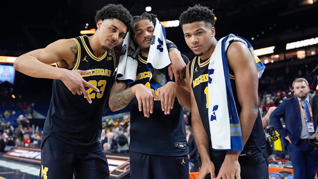 Michigan forward Yaxel Lendeborg (23), guard Roddy Gayle Jr. (11) and guard Trey McKenney (1) pose for a photo following their Final Four win against Arizona at Lucas Oil Stadium in Indianapolis on Saturday, April 4, 2026.