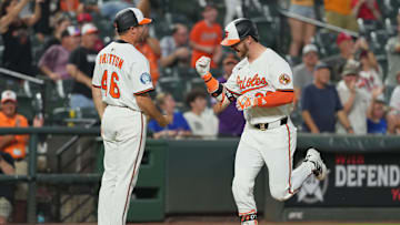 Jun 24, 2025; Baltimore, Maryland, USA; Baltimore Orioles designated hitter Ryan O’Hearn (32) is greeted by coach Buck Britton (46) following his solo home run during the seventh inning against the Texas Rangers at Oriole Park at Camden Yards. Mandatory Credit: Mitch Stringer-Imagn Images