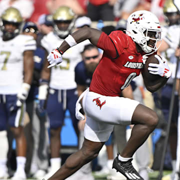 Sep 21, 2024; Louisville, Kentucky, USA;  Louisville Cardinals wide receiver Chris Bell (0) runs the ball against the Georgia Tech Yellow Jackets during the first half at L&N Federal Credit Union Stadium. Mandatory Credit: Jamie Rhodes-Imagn Images