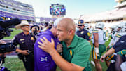 Oct 18, 2025; Fort Worth, Texas, USA; TCU Horned Frogs head coach Sonny Dykes and Baylor Bears head coach Dave Aranda meet at midfield following a game at Amon G. Carter Stadium. Mandatory Credit: Raymond Carlin III-Imagn Images