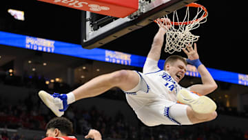 Mar 9, 2025; St. Louis, Missouri, USA;  Drake Bulldogs guard Bennett Stirtz (14) dunks against Bradley Braves guard Christian Davis (5) during the second half of the Missouri Valley Conference Tournament Championship at Enterprise Center. Mandatory Credit: Jeff Curry-Imagn Images