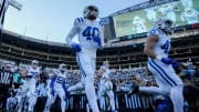 Indianapolis Colts cornerback Jaylon Jones (40) and Indianapolis Colts safety Trevor Denbow (43) take the field with their teammates Sunday, Nov. 5, 2023, before a game against the Carolina Panthers at Bank of America Stadium in Charlotte.