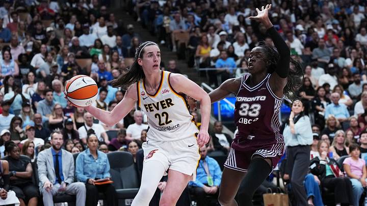Aug 18, 2026; Toronto, Ontario, CAN; Indiana Fever guard Caitlin Clark (22) controls the ball as Toronto Tempo forward Ornella Bankole (33) tries to defend during the fourth quarter at Scotiabank Arena. Mandatory Credit: Nick Turchiaro-Imagn Images