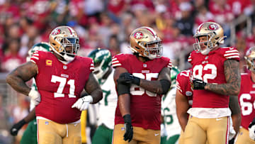Sep 9, 2024; Santa Clara, California, USA; San Francisco 49ers guard Aaron Banks (center) stands with offensive tackle Trent Williams (71) and tight end Eric Saubert (right) during the second quarter against the New York Jets at Levi's Stadium. Mandatory Credit: Darren Yamashita-Imagn Images