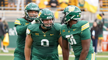 Nov 1, 2025; Waco, Texas, USA; Baylor Bears defensive lineman Cooper Lanz (9) celebrates a sack with teammates during the second half against the UCF Knights at McLane Stadium. Mandatory Credit: Raymond Carlin III-Imagn Images