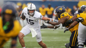 Penn State quarterback Drew Allar runs the ball and shakes off a tackle during the fourth quarter against the West Virginia Mountaineers.