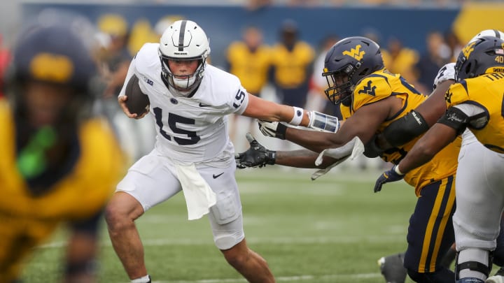 Penn State quarterback Drew Allar runs the ball and shakes off a tackle during the fourth quarter against the West Virginia Mountaineers.