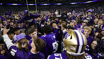 Oct 5, 2024; Seattle, Washington, USA; Washington Huskies fans rush the field to congratulate players following a victory against the Michigan Wolverines at Alaska Airlines Field at Husky Stadium. Mandatory Credit: Joe Nicholson-Imagn Images