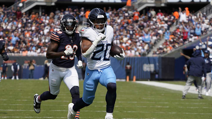 Sep 8, 2024; Chicago, Illinois, USA; Tennessee Titans running back Tony Pollard (20) runs for a touchdown  against the Chicago Bears during the first half at Soldier Field. Mandatory Credit: David Banks-Imagn Images