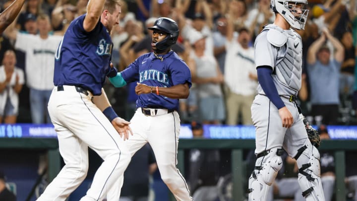 Seattle Mariners pinch runner Ryan Bliss (1) scores the winning run against the Detroit Tigers during the ninth inning at T-Mobile Park on Aug 8.