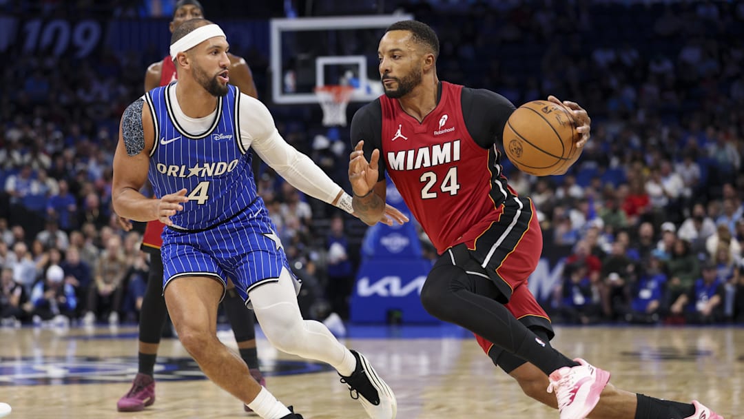 Dec 5, 2025; Orlando, Florida, USA; Miami Heat guard Norman Powell (24) drives to the hoop past Orlando Magic guard Jalen Suggs (4) in the first quarter at Kia Center. Mandatory Credit: Nathan Ray Seebeck-Imagn Images