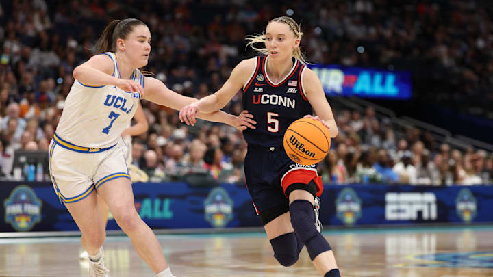 Connecticut Huskies guard Paige Bueckers (5) dribbles against UCLA Bruins guard Elina Aarnisalo (7) during the third quarter in a semifinal of the women's 2025 NCAA tournament at Amalie Arena. Connecticut Huskies guard Paige Bueckers (5) dribbles against UCLA Bruins guard Elina Aarnisalo (7) during the third quarter in a semifinal of the women's 2025 NCAA tournament at Amalie Arena.